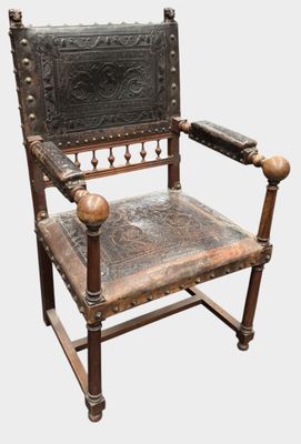 a wooden chair with a leather seat on it