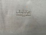 a close up of a silver plate with a logo on it