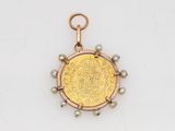 an image of a gold coin with pearls on a chain