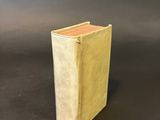 a close up of a book on a table with a black background