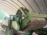 a green truck that is parked inside of a building