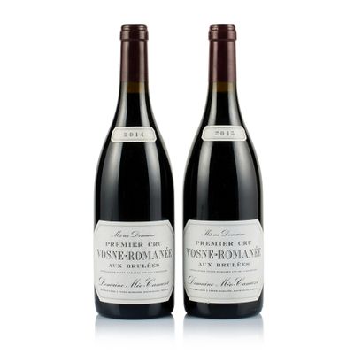 two bottles of wine sitting next to each other on a white surface