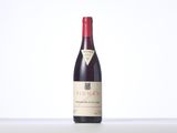 a bottle of red wine sitting on top of a table