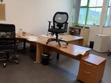 a desk with a chair and a chair in an office