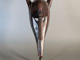 a close up of a wooden sculpture of a person ' s head