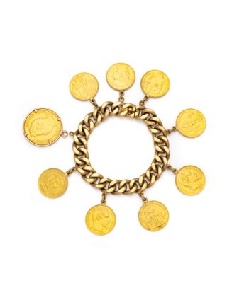 un bracelet en or orné de pièces et entouré d'une chaîne