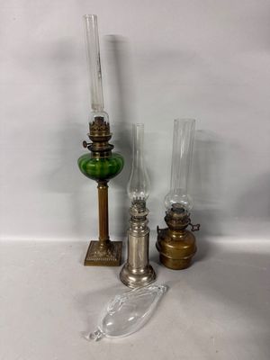 three different types of oil lamps on the table