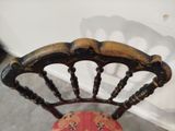 a wooden chair with a red cushion on it