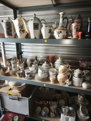 many different types of pottery on the shelves in this room