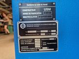 a sign on the side of a blue machine