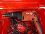 a drill in a red box with a cord in it