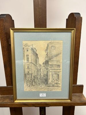 drawing of a street scene in a frame on a wooden easel