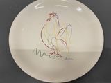 a white plate with a drawing of a rooster on it