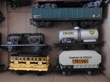 several toy trains are lined up on a shelf in a box