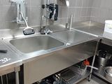 a stainless steel sink in a kitchen with a faucet