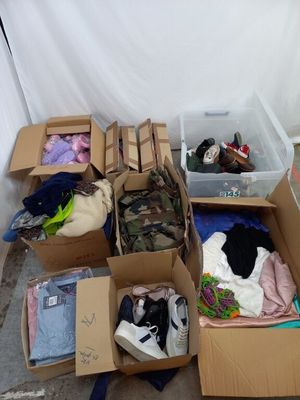 de nombreux cartons de vêtements et d'autres objets dans une pièce