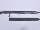 two knives are laying side by side on a white surface