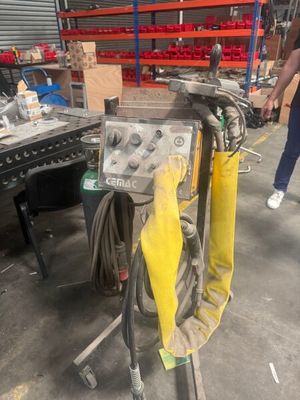 a machine that is sitting on a stand in a warehouse