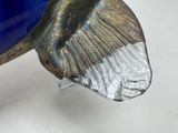 a blue glass vase with a gold fish decoration on it
