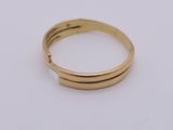 a close up of a gold ring on a white surface
