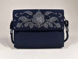 a blue clutch bag with a floral design on the front