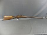 a rifle that is sitting on top of a table