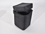 an empty black bag sitting on top of a white table