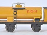 a yellow train car with a yellow tank on it