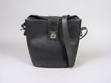 a black leather bag with a metal clasp on the front