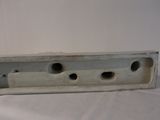 a white piece of metal that has holes in it