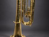 a brass trumpet on a black background