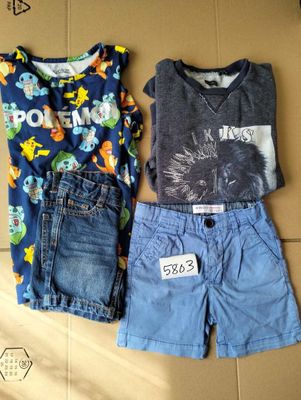 two pairs of shorts and a t - shirt are on the floor