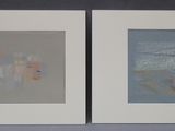 two framed pictures of a couple of paintings on a wall