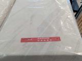 a stack of mattresses sitting on top of a cart in a warehouse