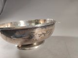 a silver bowl sitting on top of a table