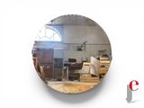 a round mirror that is hanging on the wall