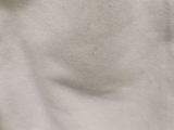 a close up of a white shirt with a black cat on it ' s chest