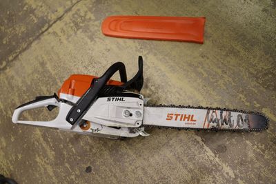 an image of a chainsaw sitting on the ground