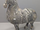 statue d'un cheval en pierre, avec une étiquette autour du cou