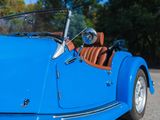 a blue car parked on the side of the road