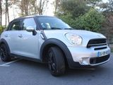 a picture of a white mini cooper parked in a parking lot