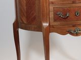 a marble top chest of drawers on a wooden stand
