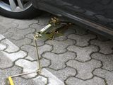 a car that has a jack on the ground next to a car