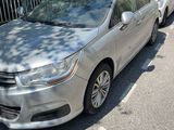 a silver car that is parked on the side of the road