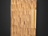 a gold cigarette case with a cigarette in it on a black background