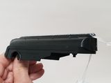 a person holding a black toy gun in their hand