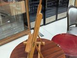 a table with a easel on top of it in a store