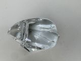 a clear glass object on a white surface