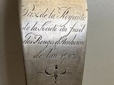 a silver spoon with writing on it sitting on a table