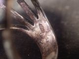 a close up of a silver ring with a diamond on it